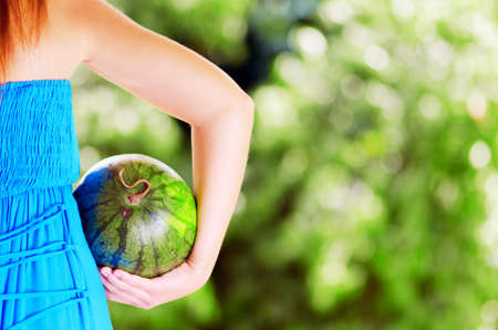 Young woman with watermelon in hands.の写真素材