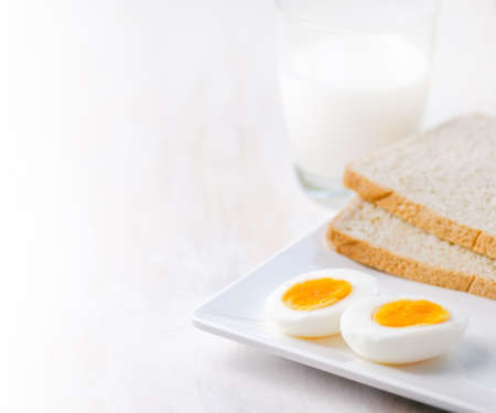 Boiled eggs, toasts and glass of milk の写真素材
