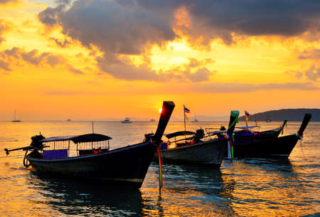 Traditional thai boats at sunset beach  Ao Nang, Krabi province の写真素材