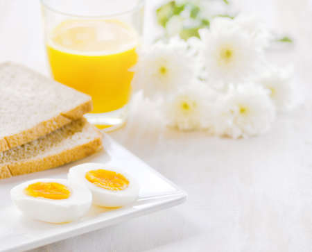 Boiled egg, toasts and orange juice.