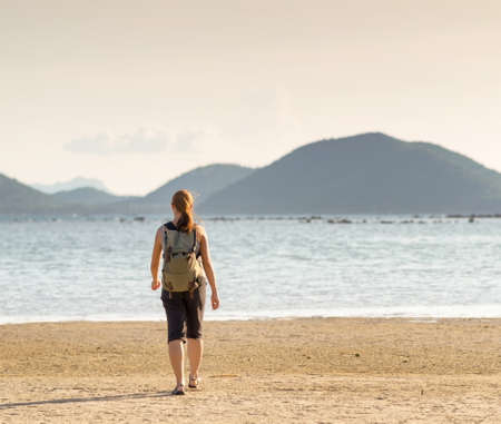 Young woman hiking with backpack.