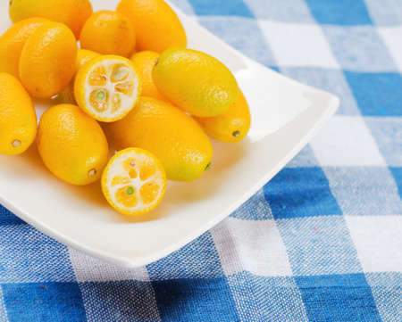 Yellow kumquat on nature background.
