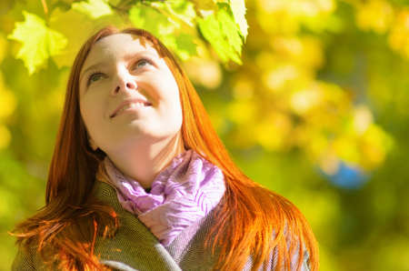 Young woman in autumn park. Outdoor portrait.