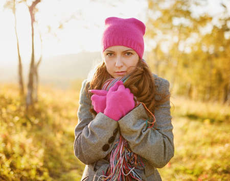 Young woman walking in the fall season. Autumn outdoor portrait.の写真素材