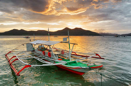 Traditional boats at sunset. Philippines. の写真素材