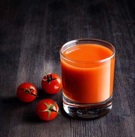 Glass of tomato juice on a table.の写真素材