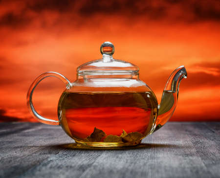 Teapot of fresh tea on sky background.の写真素材