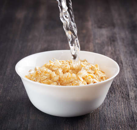 Bowl of oatmeal on wooden table.の写真素材