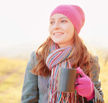 Young woman enjoying the fall season. Autumn outdoor portrait.の写真素材