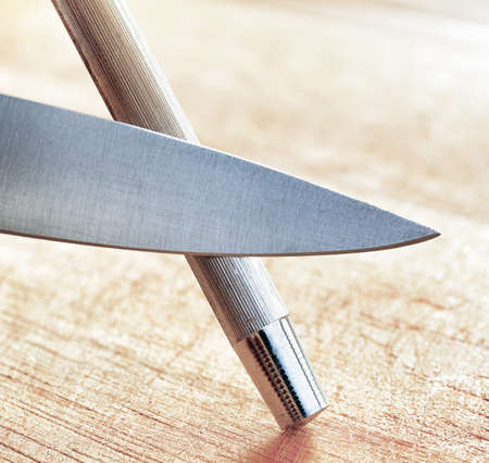 Sharpening of knife in a kitchen.の写真素材