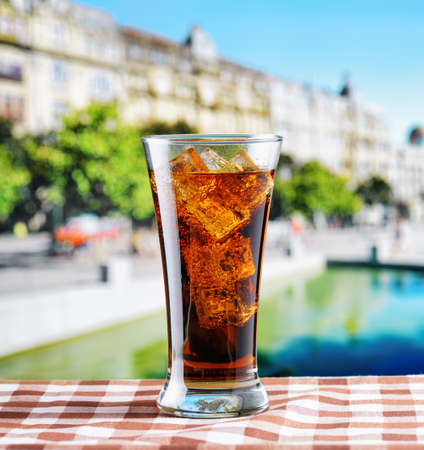 Glass of cola with ice on a table in cafe.の写真素材