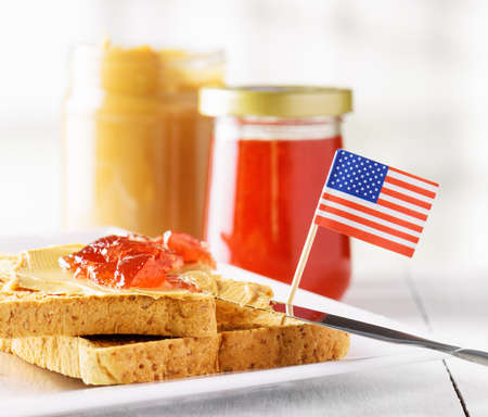 Toasts with peanut butter and strawberry jam on white table. American breakfast.の写真素材