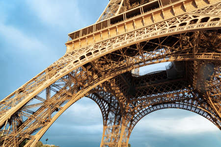 Lacy arches of the Eiffel Tower in Paris, France. Paris is one of the most popular tourist...