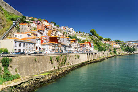 Colorful facades of old houses on embankment of the Douro River  in Porto, Portugal. Porto is one of...