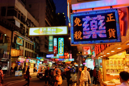 HONG KONG â JANUARY 28, 2015: Illuminated signs on the street of night city. Hong Kong is a leading financial centre of the world.のeditorial素材