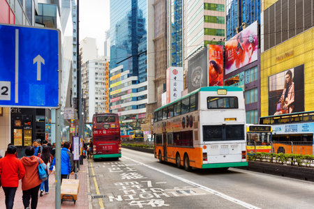 HONG KONG - JANUARY 28, 2015: Decker buses on the central streets. Hong Kong is a leading financial centre of the world.のeditorial素材