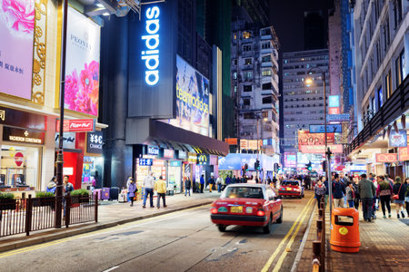 HONG KONG - JANUARY 31, 2015: Taxi and illuminated signs on the street of night city. Hong Kong is popular tourist destination of Asia and leading financial centre of the worldのeditorial素材