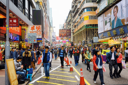 HONG KONG - FEBRUARY 1, 2015: Pedestrians on streets of city Hong Kong. Hong Kong is a popular tourist attraction of Asia and leading financial centre of the world. HONG KONG - FEBRUARY 1, 2015: Pedestrians on streets of city Hong Kong. Hong Kong is a popular tourist attraction of Asia and leading financial centre of the world.