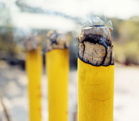 Closeup view of burning incense sticks during prayer at the Buddhist temple, Po Lin Monastery in Hong Kong. Hong Kong is popular tourist destination of Asia.の写真素材