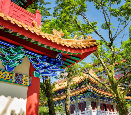 Closeup view of gilded red wooden roofs in traditional Chinese-style at the Buddhist temple, Po Lin Monastery at Lantau Island, in Hong Kong. Hong Kong is popular tourist destination of Asia.のeditorial素材