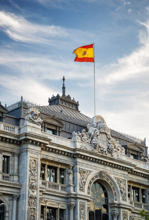 The flag of Spain fluttering on building of the Bank of Spain (Banco de Espana) in Madrid, Spain. Madrid is a popular tourist destination of Europe.のeditorial素材