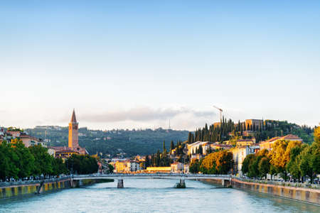 View of the Ponte Nuovo (New Bridge) over the Adige River in Verona (Italy) at dawn. Blue sky in background. Verona is a popular tourist destination of Europe.の写真素材
