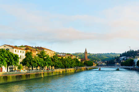 Beautiful view of the Adige River and the Ponte Nuovo (New Bridge) in Verona, Italy. Verona is a popular tourist destination of Europe.の写真素材