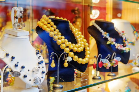 VENICE, ITALY - AUGUST 24, 2014: Original jewelry from Murano Glass in shop window on the Rialto Bridge. Beautiful beads, necklaces and earrings. Venice is a popular tourist destination of Europe.のeditorial素材