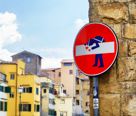 FLORENCE, ITALY - AUGUST 25, 2014: Street art at historic center of Florence, Tuscany. Traffic sign turned into humorous art by French Artist Clet Abraham. It is a popular attraction of Florence.のeditorial素材