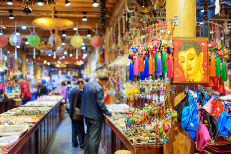 LIJIANG, YUNNAN PROVINCE, CHINA - OCTOBER 23, 2015: Tourists looking at traditional Chinese souvenirs in big gift shop of the Old Town of Lijiang. Lijiang is a popular tourist destination of Asia.のeditorial素材