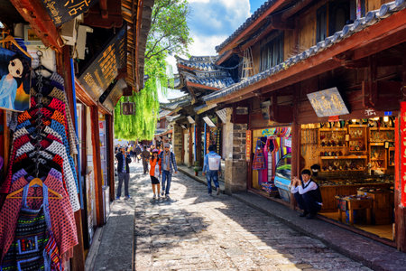 LIJIANG, YUNNAN PROVINCE, CHINA - OCTOBER 23, 2015: Souvenir shops on street of the Old Town of Lijiang. The Old Town of Lijiang is a popular tourist destination of Asia.のeditorial素材
