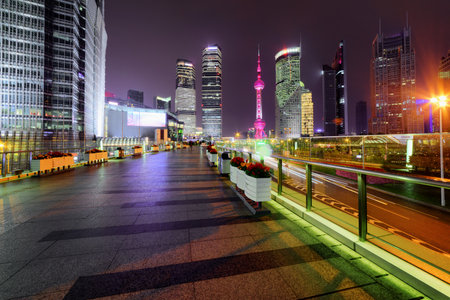 Night view of skyscrapers from pedestrian side of Century Avenue in downtown at the Pudong New District (Lujiazui), Shanghai, China. The Oriental Pearl Tower is visible in background.のeditorial素材