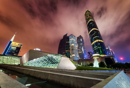 Amazing night view of the Guangzhou Opera House, skyscrapers and other modern buildings at the Zhujiang New Town, China. The Guangzhou International Finance Centre (West Tower) is visible at right.のeditorial素材