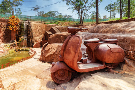 Dalat, Vietnam - March 31, 2016: Big clay sculpture of scooter at amazing canyon in the Dalat Star place, Da Lat. The Dalat Star is a popular tourist destination of Asia.のeditorial素材