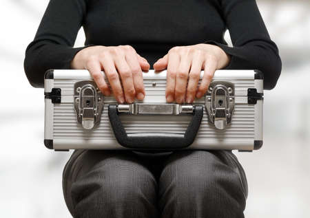Business woman holding an aluminium briefcase.の写真素材