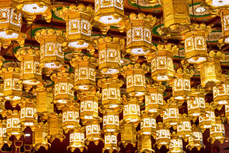 Oriental Chinese golden ceiling lanterns in a Buddhist temple.の写真素材