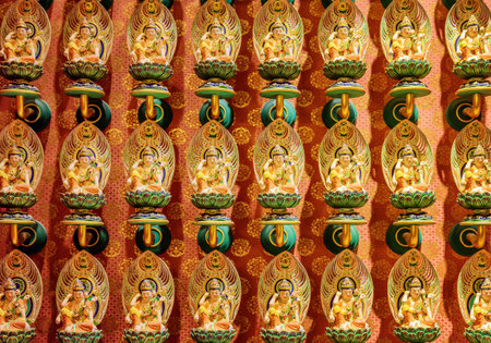 Singapore - February 17, 2017: Wall with small Buddha statues inside the Buddha Tooth Relic Temple in the Chinatown district. The Buddha Tooth Relic Temple is a popular tourist destination of Asia.のeditorial素材