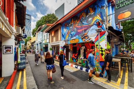 Singapore - February 19, 2017: Tourists walking along gift shops at Haji Lane. Decorative painted wall of old house. Amazing street art at the Muslim quarter (Arab quarter). Graffiti in Singapore.のeditorial素材