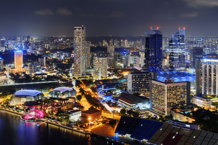 Fantastic night view of downtown in Singapore. Amazing skyscrapers and other modern buildings on dark sky background. Top view of Raffles Avenue. Beautiful cityscape.のeditorial素材