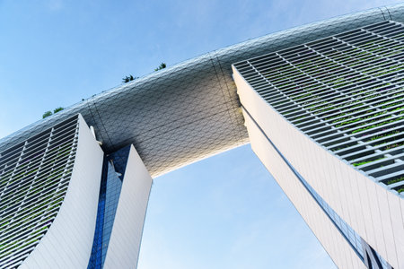Singapore - February 17, 2017: Bottom view of the Marina Bay Sands Hotel. The famous towers and the SkyPark bridge on the top of skyscrapers. The Marina Bay Sands is a popular tourist attraction.のeditorial素材