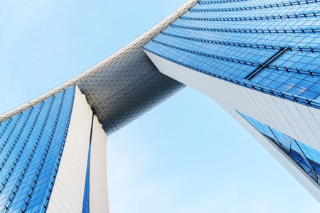 Singapore - February 17, 2017: Wonderful bottom view of the famous Marina Bay Sands Hotel. Blue glass towers and the SkyPark bridge on the top of skyscrapers.のeditorial素材