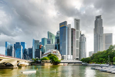 Amazing view of skyscrapers and the Singapore River in downtown. Scenic modern high-rise buildings on stormy sky background. Beautiful cityscape. Singapore is a popular tourist destination of Asia.の写真素材