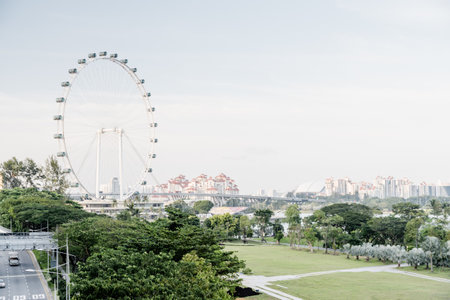 Scenic view of giant Ferris wheel at downtown of Singapore. Wonderful summer cityscape. Singapore is...