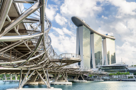 Singapore - February 19, 2017: Amazing view of the Helix Bridge. The Marina Bay Sands Hotel on blue sky background. Beautiful cityscape. Singapore is a popular tourist destination of Asia.のeditorial素材