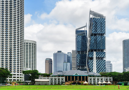 Scenic view of skyscrapers and other modern buildings in downtown of Singapore on blue sky background. Beautiful summer cityscape. Singapore is a popular tourist destination of Asia.のeditorial素材