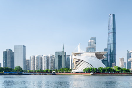 Scenic view of the Pearl River and modern buildings at the Zhujiang New Town on blue sky background. Fantastic sunny summer cityscape in downtown of Guangzhou, China. Guangzhou skyline.のeditorial素材