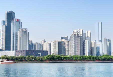 Fantastic Guangzhou skyline. Wonderful view of the Pearl River and skyscrapers at the Zhujiang New Town on blue sky background. Modern buildings at downtown of Guangzhou, China. Sunny cityscape.のeditorial素材