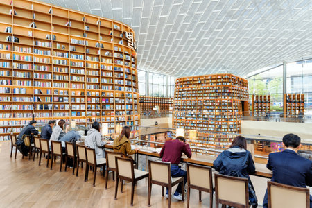Seoul, South Korea - October 14, 2017: Visitors at the second floor of Starfield Library. Huge bookshelves are visible in background. The public library is a popular attraction of Seoul.のeditorial素材