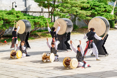 Seoul, South Korea - October 15, 2017: Performance with Korean traditional drums beside the National Folk Museum of Korea at Gyeongbokgung Palace. The palace is a popular tourist destination of Asia.のeditorial素材