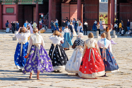 Seoul, South Korea - October 15, 2017: Tourists wearing colorful Korean traditional dress Hanbok in Gyeongbokgung Palace. Gyeongbokgung Palace is a popular tourist destination of Asia.のeditorial素材